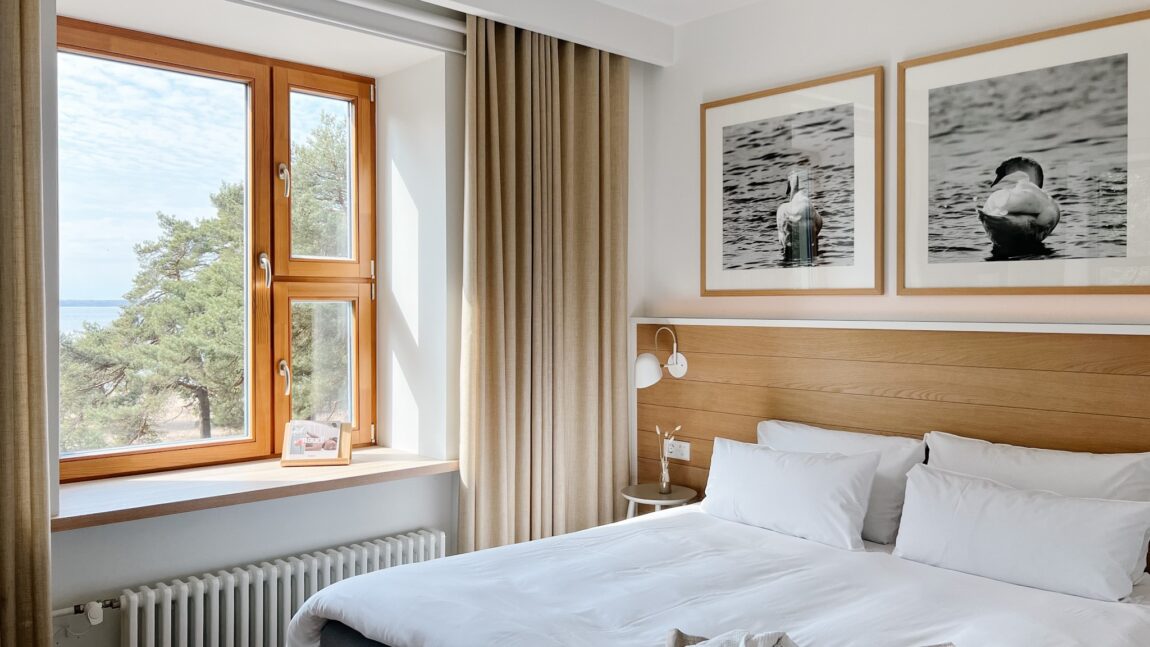 LaSpa beach house room with sea view, wooden window frame, soft textiles, natural light and Nordic interior