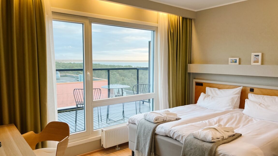 LaSpa superior room with twin beds, balcony and sea view, large window, soft natural light and Nordic interior